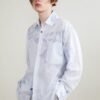 The light blue long sleeve shirt is smooth and draped