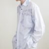 The light blue long sleeve shirt is smooth and draped