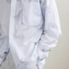 The light blue long sleeve shirt is smooth and draped